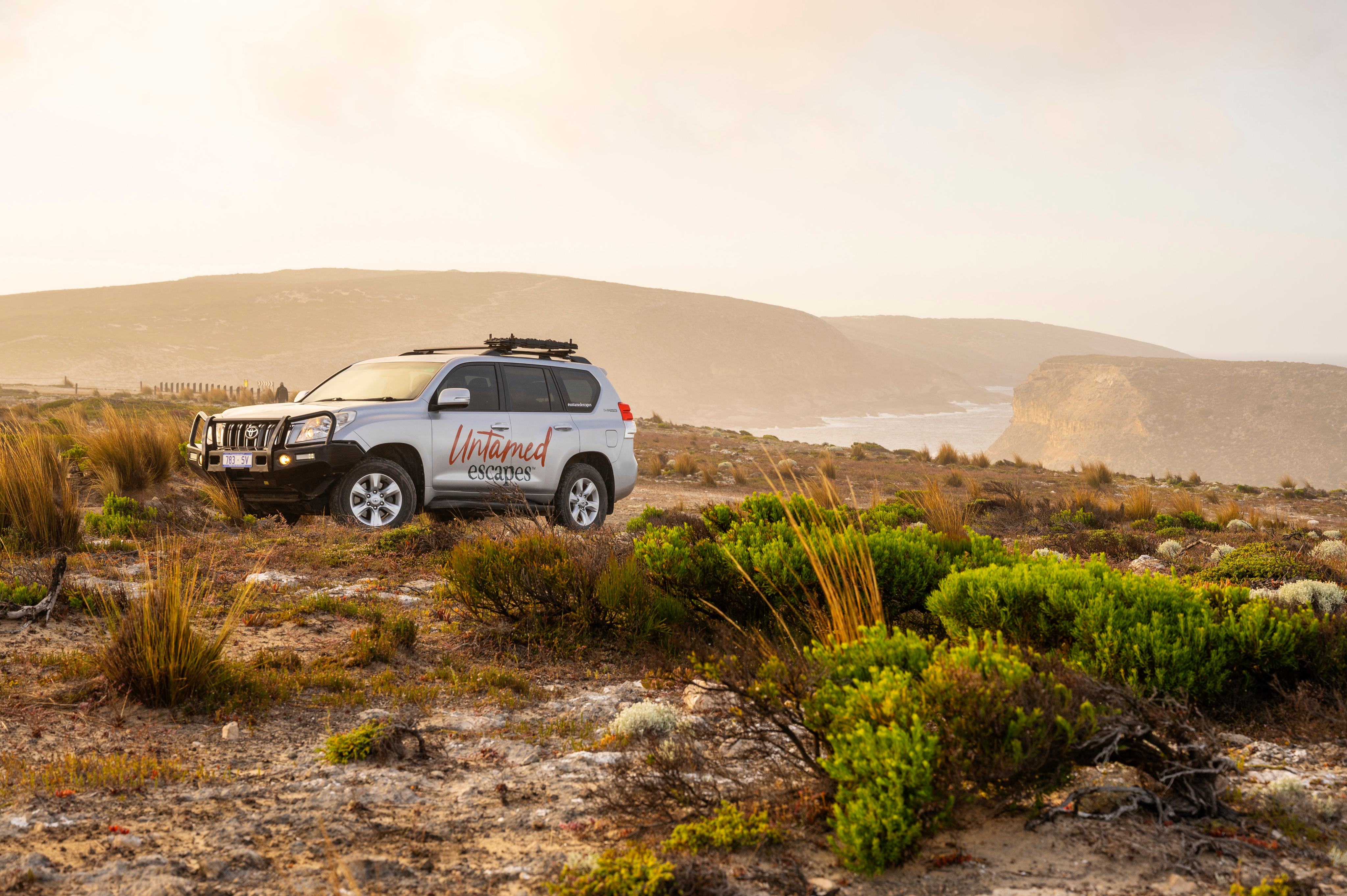 Anders brand wordmark in white placed on top of an image of a modern interior design.